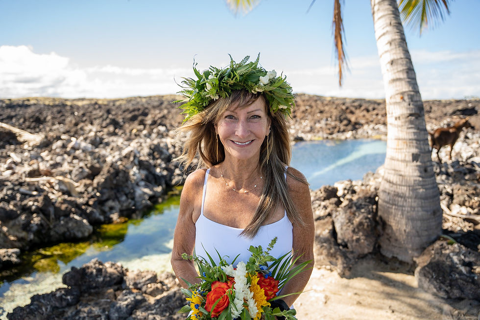 Thumbnail: Bride with foliage crown and red-yellow bouquet stands near ocean, honoring Kona’s sacred shoreline