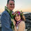 Thumbnail: Couple stands close near Kona’s rocky shore—adorned in formal attire with floral leis and crown, bathed in sunset light as oc