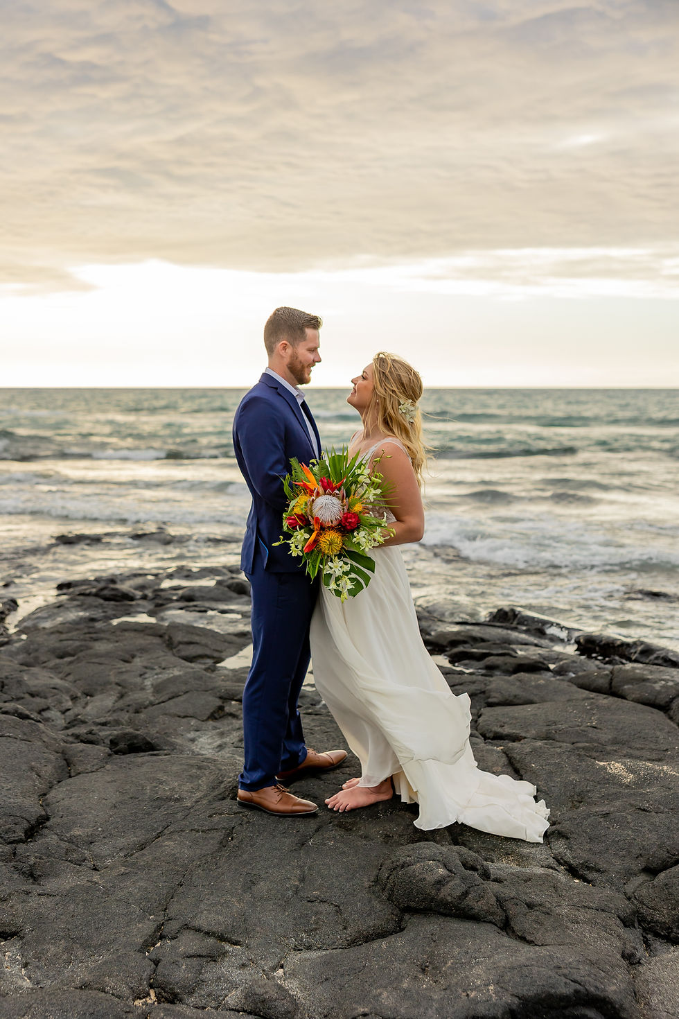Thumbnail: Wedding portrait with tropical bouquet and ocean horizon in Hawaiian setting.