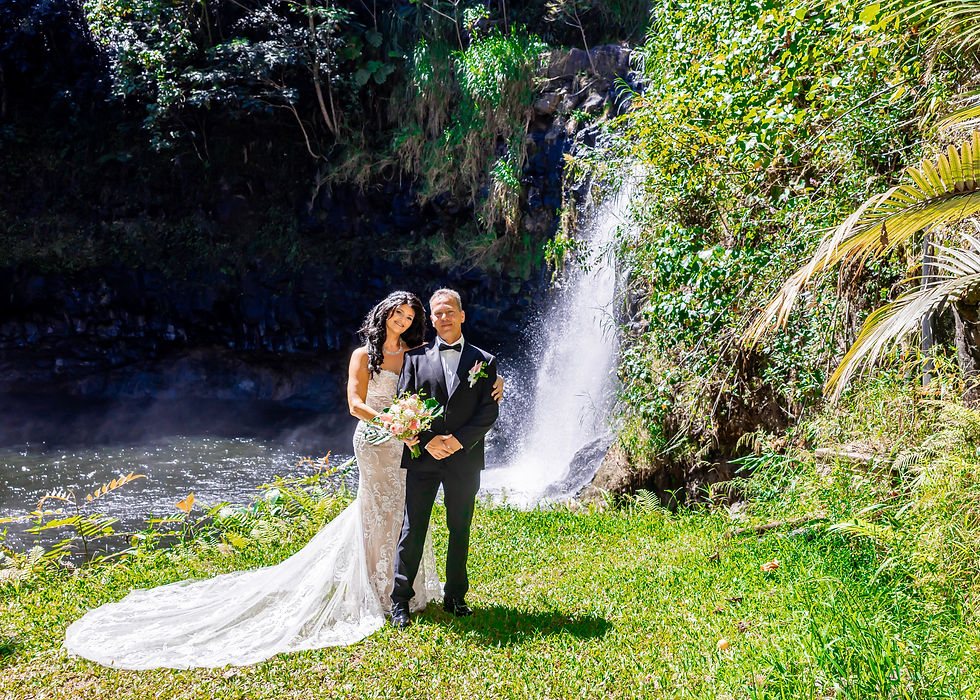Newlyweds smiling as they pose during their elopement wedding with Kona Wedding Officiant during their private Hawai‘i waterfall wedding at Kulaniapia Falls.