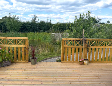 Beautiful spacious decking overlooking a pond