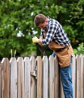 handyman repairing a broken fence.jpg