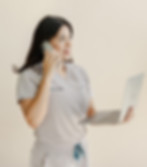 Young woman smiling while talking on the phone in a regenerative medicine clinic, representing professional care in Cancun.