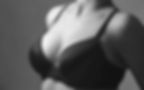 Woman after breast augmentation wearing a black bra
