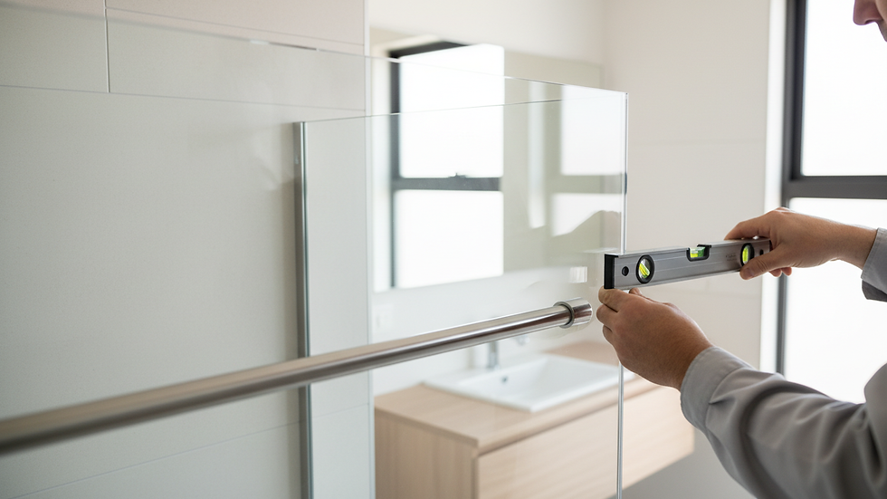 Close-up view of professional installing frameless shower door hardware
