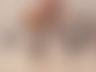 A founder in a patterned knit jumper sitting thoughtfully, hand resting on chin, suggesting reflection and strategic thinking.