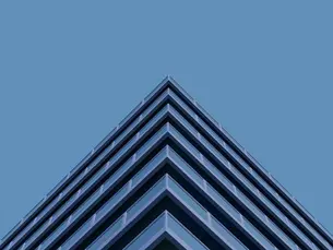 Abstract geometric architecture pointing upward, representing structured marketing strategy and scalable growth for £3m+ businesses - OSER