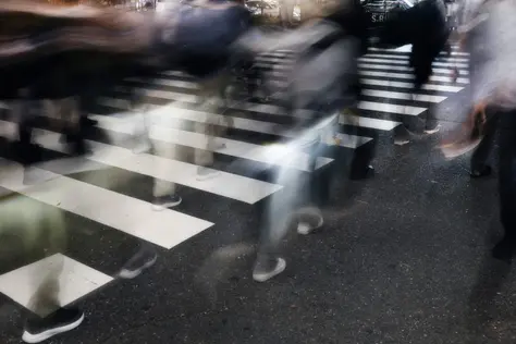 Blurred crowd walking on a zebra crossing in a city street, representing bold thinking and brands choosing distinct paths in the next era of AI-powered growth - OSER