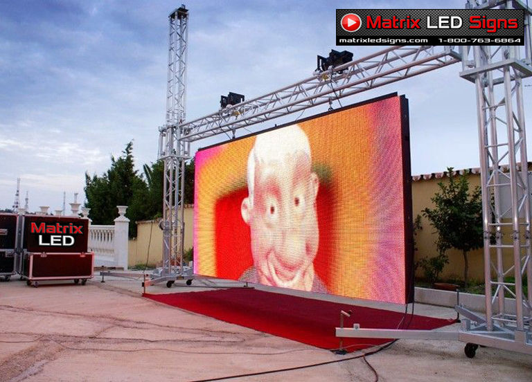 Outdoor LED stage screen display by Matrix LED Signs mounted on truss system, showcasing large event video wall for concerts, festivals, and corporate productions.