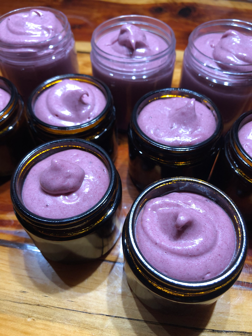 Several jars filled with pink cream, Hair Butter-Conditioning Hair Butter, ready for sale at market.