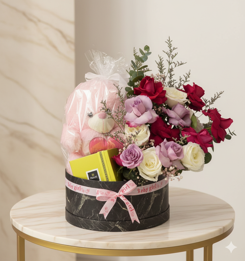 Elegant baby girl flower box with roses, teddy bear gift, and pastel blooms arranged in a premium keepsake container