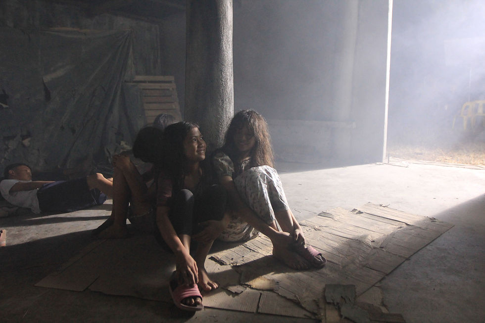 Two women seated on the floor in a shaft of light — CineBandits production gallery