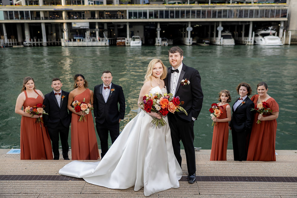 Wedding party gathers along the Chicago River for a group portrait.