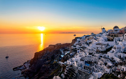 O inesquecível pôr do sol nas encostas de Oia, no topo da caldeira vulcânica de Santorini, Grécia