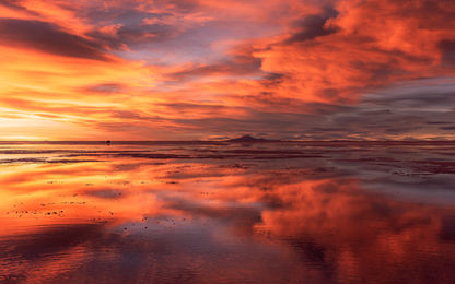 O incomparável pôr do sol no Salar de Uyuni, um espetáculo mágico de 360°, multi cênico, dramático quando combinado com as nuvens e o espelho d'água refletindo suas cores, a 89 km da cidade de Uyuni, Bolíva