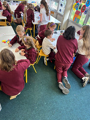 Senior pupils supporting junior Maths classes.jpg