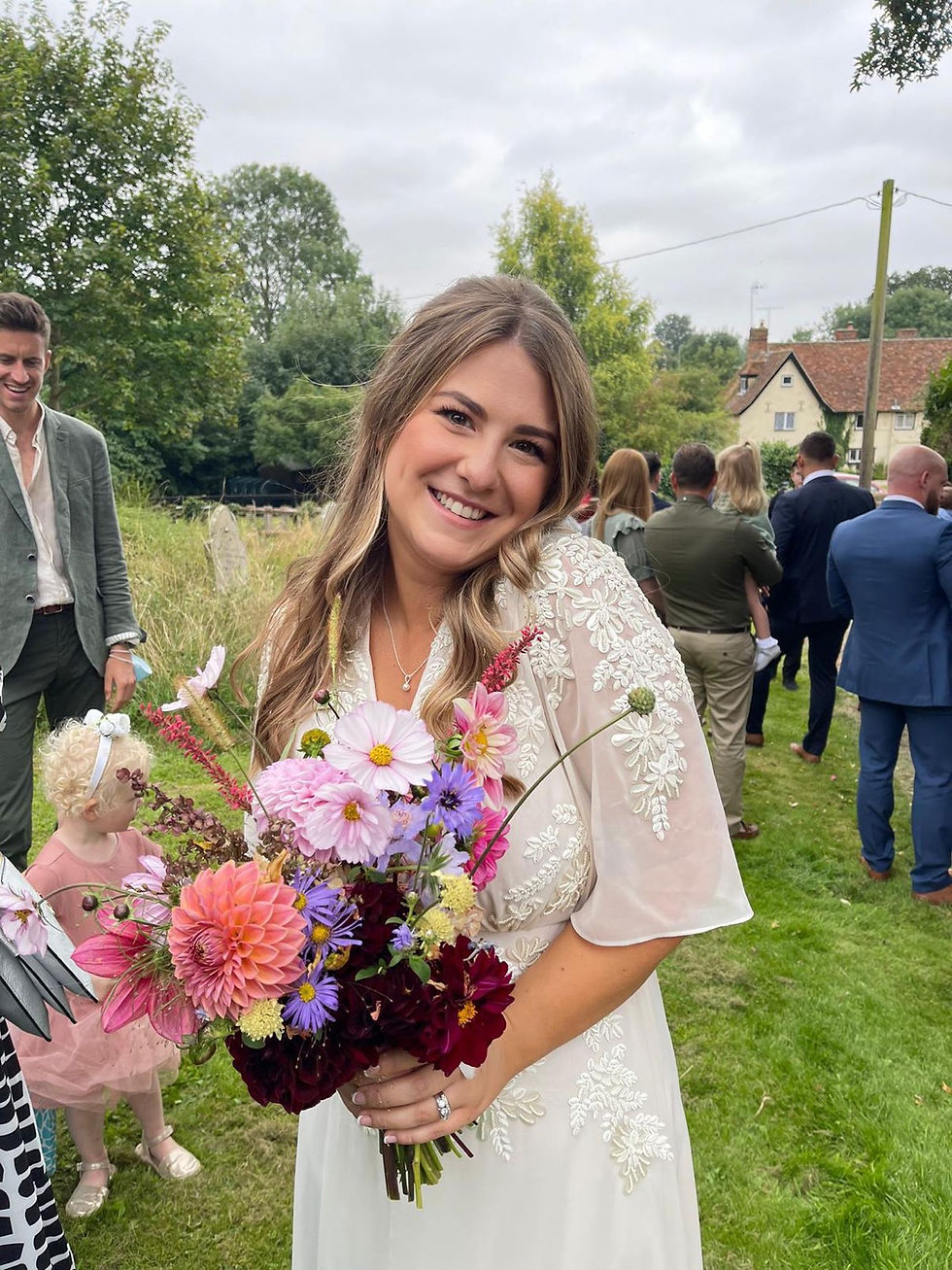 Beautiful Bride holding her bouquet dahlias