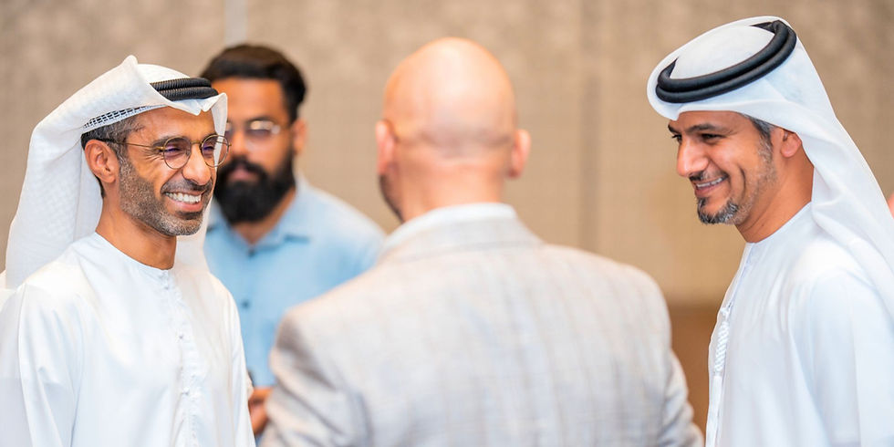 Executive coach Saeed Alghafri smiling during an engaging group coaching conversation