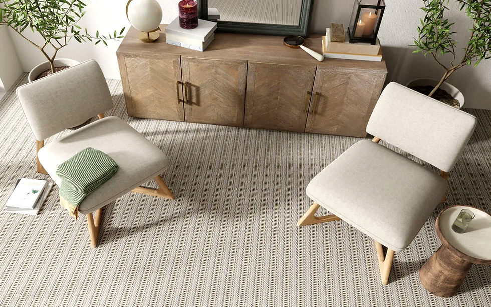 Modern beige living room with two chairs, wooden cabinet, candles, and potted plants on a Kaleen striped carpet, One Love i the color Watermelon, in a calm setting