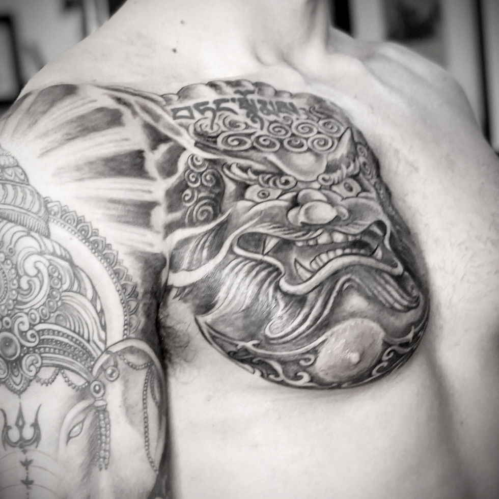 Close-up view of a tattoo artist sketching a custom design on paper