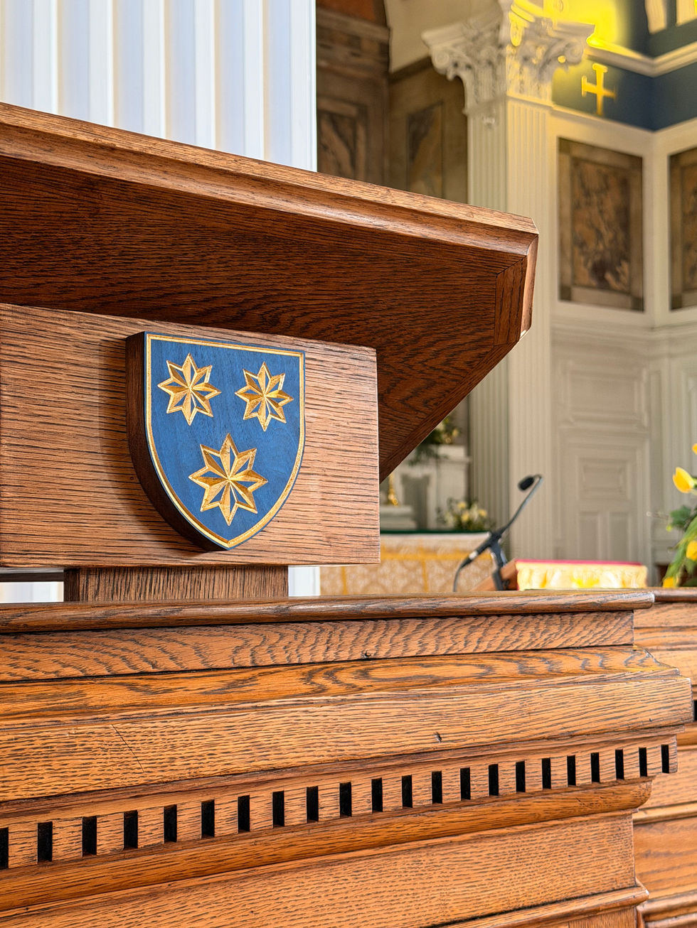 Wooden podium with a blue shield emblem.