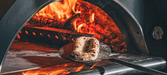 focaccia inside a wood-fired oven at 450°C