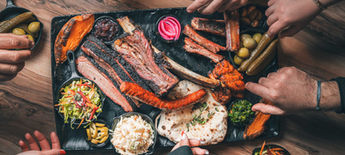 Barbecue platter with brisket, ribs, and sides on a table