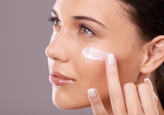 Girl applying Moisturizer