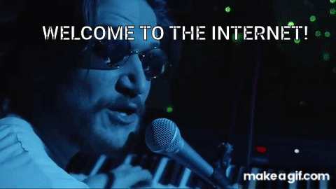 Man wearing sunglasses plays piano, singing into mic with blue lighting. "WELCOME TO THE INTERNET!" text overlays. Mood is intense.