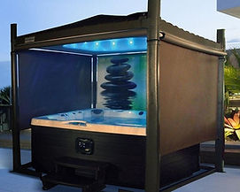 A gazebo with an automated hot tub cover, fully raised with decorative screens blocking out the background