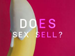 A suggestive banana covered in white icing on a bold background, used as a visual metaphor for the psychology of sex appeal in marketing and advertising.