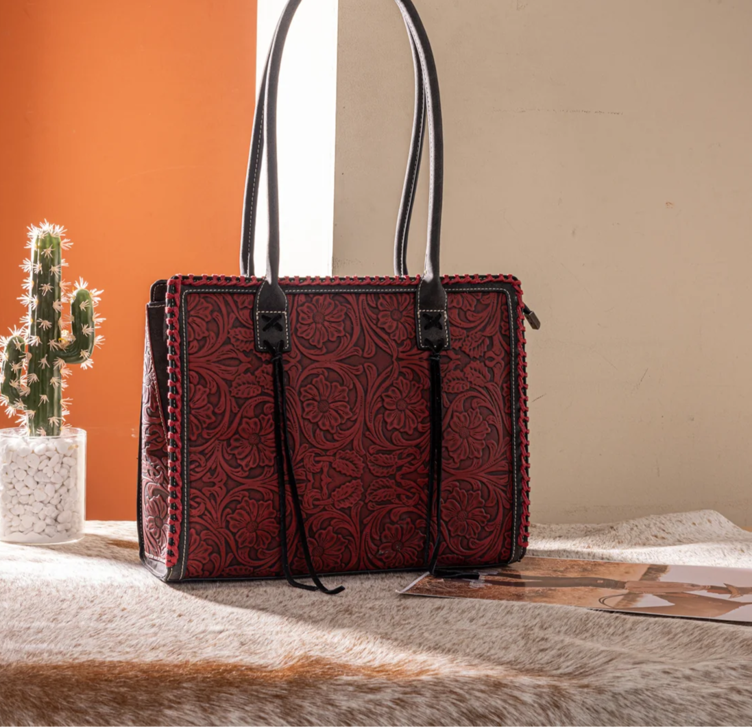 Montana West Western tote bag with embossed floral tooling, tassel accents, dual handles and top zipper closure.