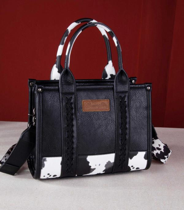 Black Wrangler Western tote crossbody bag with black and white cow print accents, whipstitch detailing, top handles and shoul