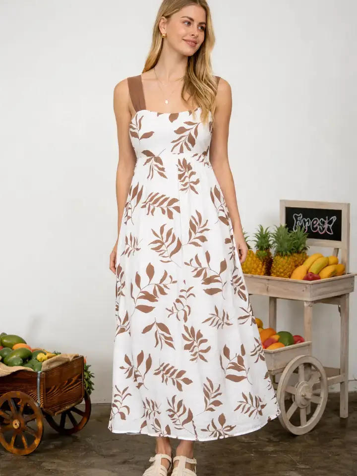 flowy white maxi dress with mocha leaf print and adjustable tie-back detail in coastal boho style