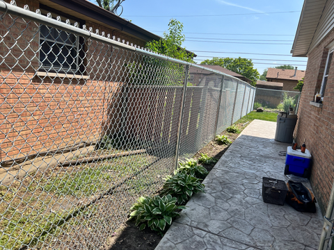Customer is good friends with her neighbors but both having big dogs turned out to be a challenge for them. We decided to go with a 6' galvanized chainlink fence so they can still talk while still letting the dogs out to play.