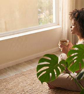 Girl looking out window drinking tea.jpg