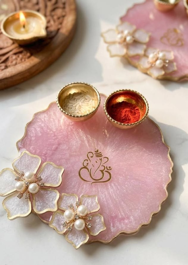 pooja thali with a Ganesha motif and two small bowls, placed on a white marble surface, designed by Salsabila Academy