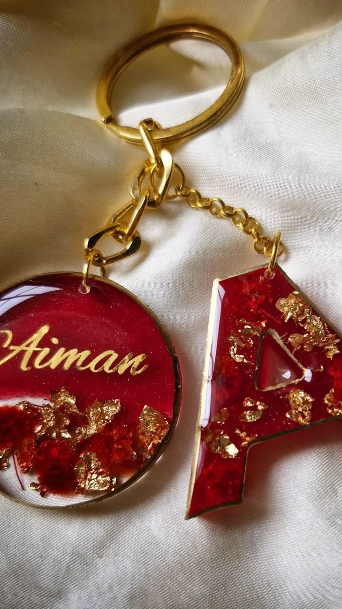 Custom resin alphabet keychain with gold flakes and a tassel, showcased for Salsabila Academy's resin workshop