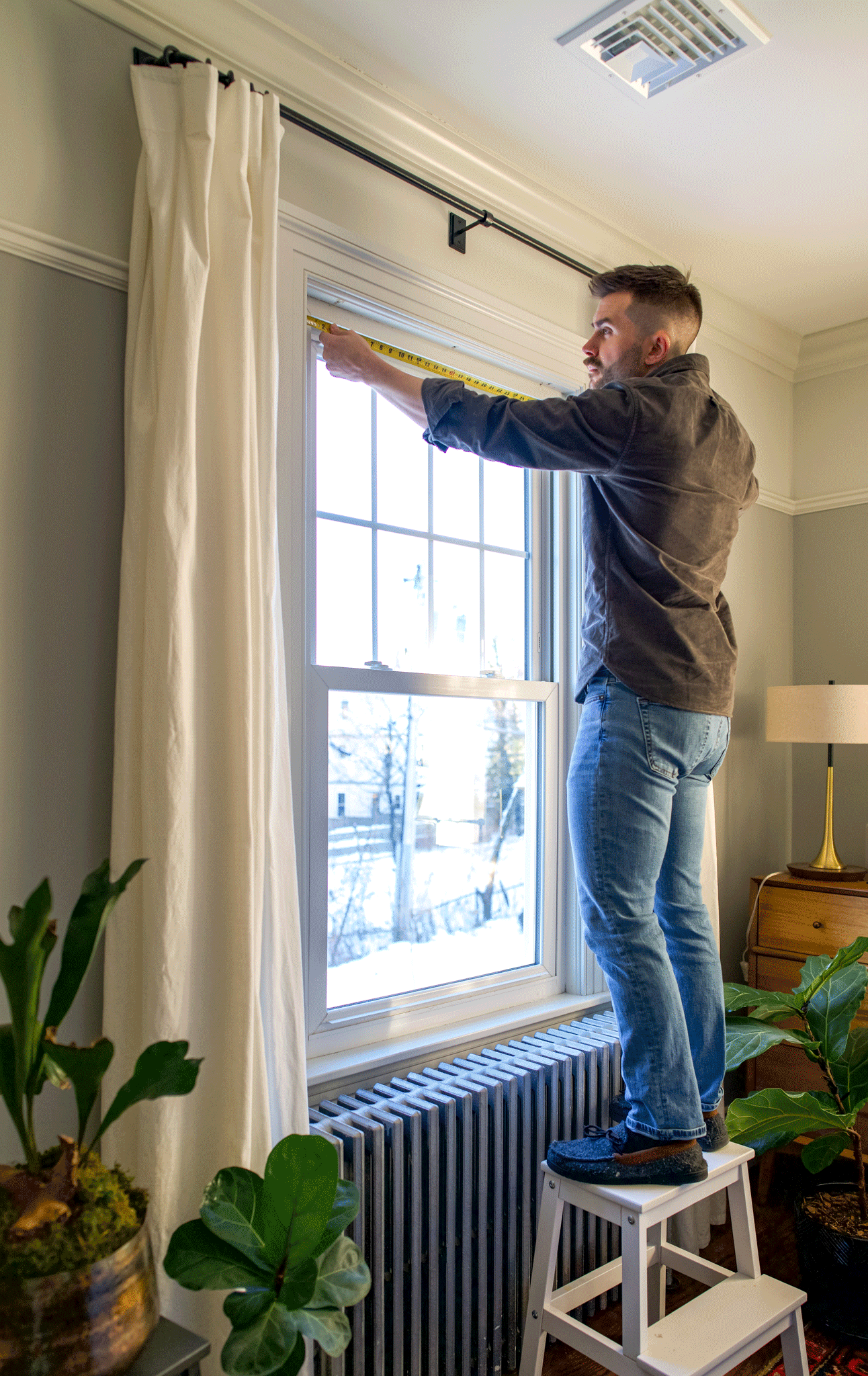 GIF of man measure a window in order to install window shades