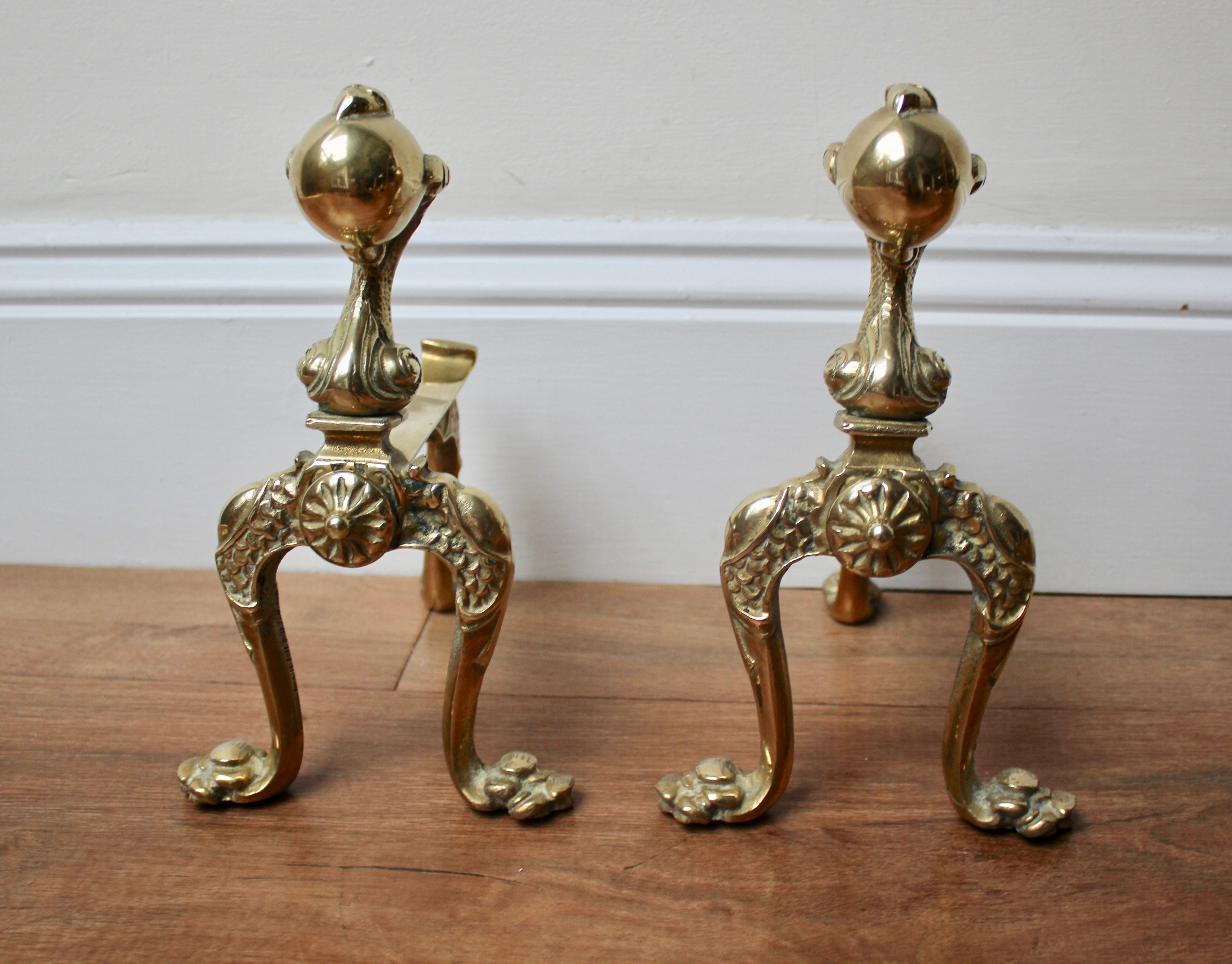 A Pair of Antique Sold Brass Claw and Ball Fire Dogs