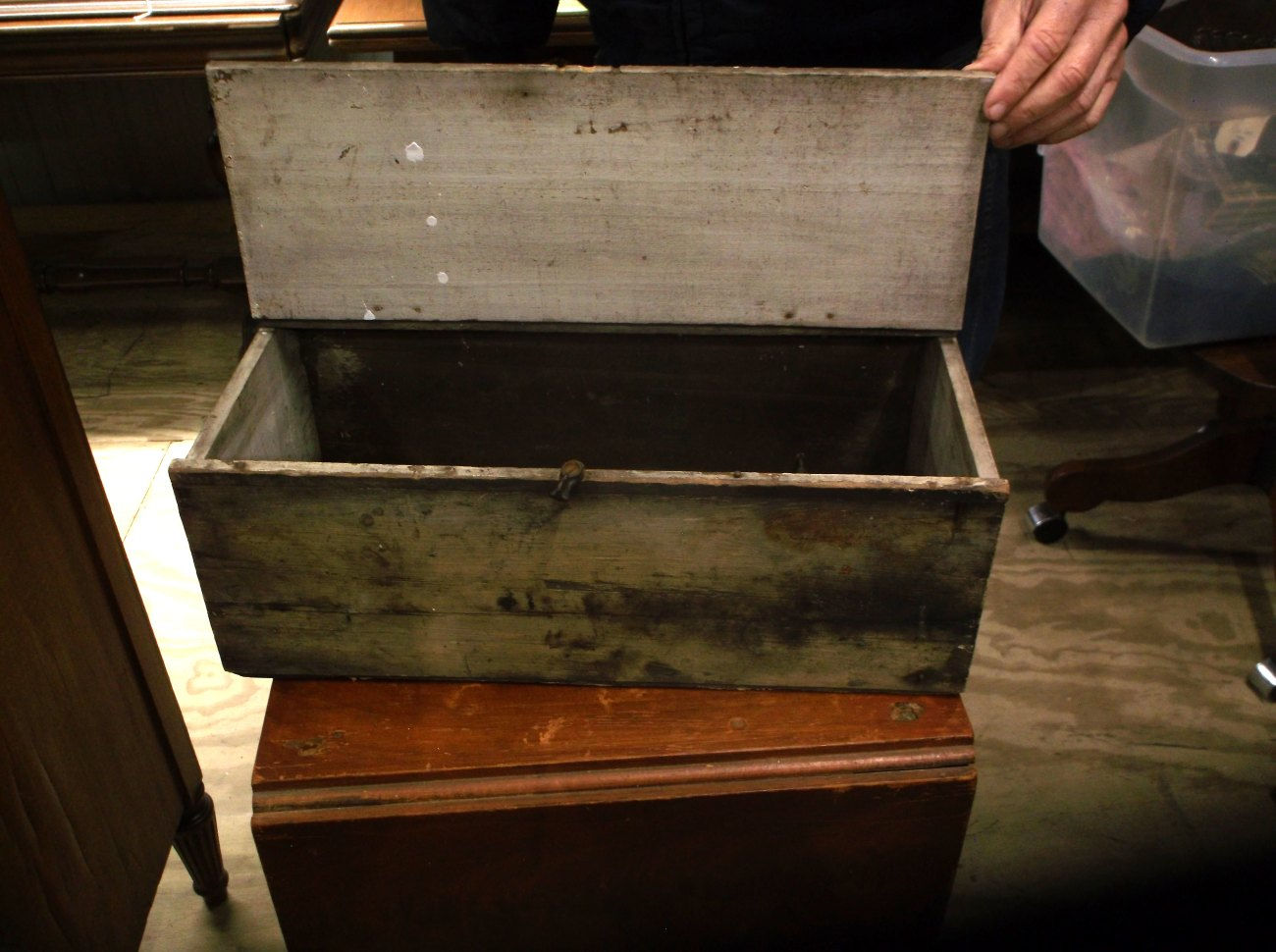 Interior view of Vintage wooden tool box with hinged lid and aged paint finish