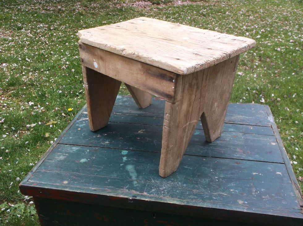 Small primitive wooden bench with rustic weathered finish and early farmhouse styling.