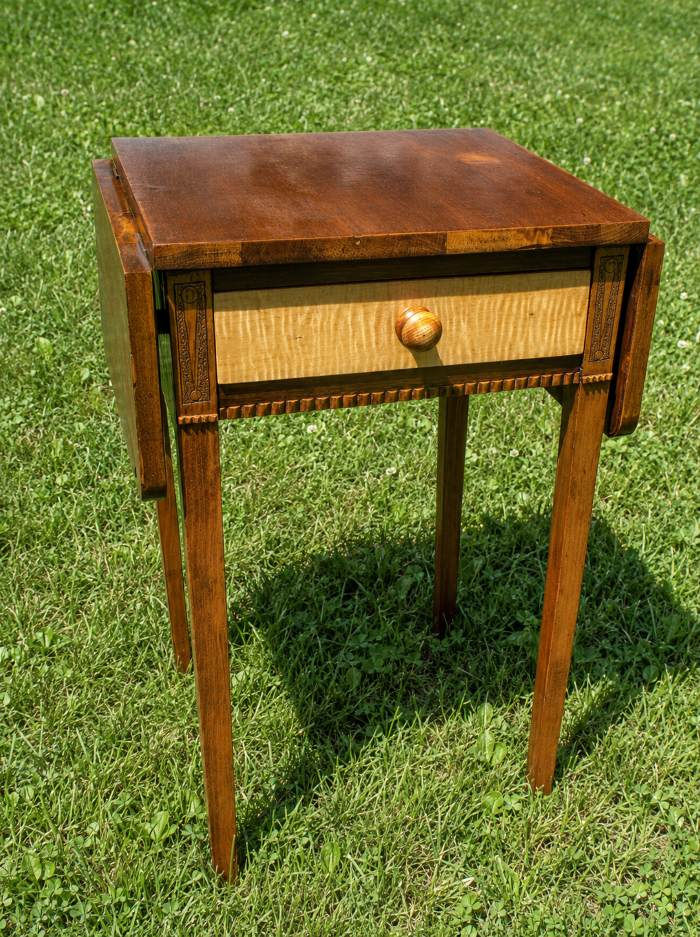 mahogany drop-leaf stand with tiger maple drawer front and folded side leaves