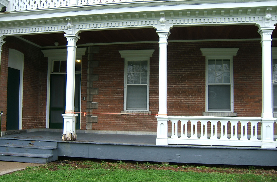 Damaged porch railing detached for repair at the Man repairing porch at the Oneida Community Mansion House
