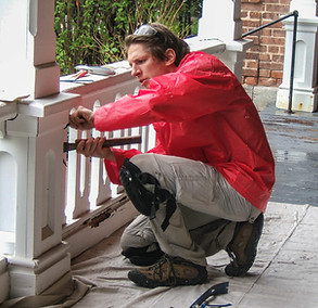 Man repairing porch at the Oneida Community Mansion House