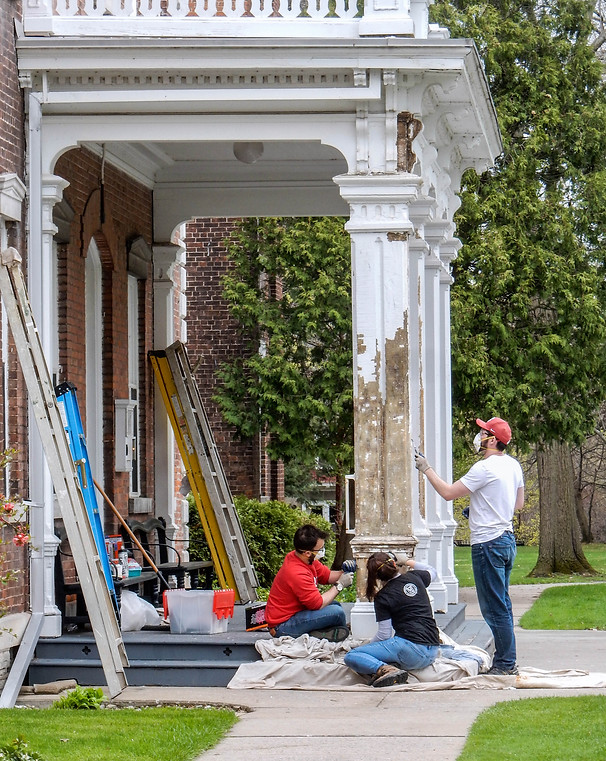 Cornell students scrape the old paint at the Oneida Community Mansion House