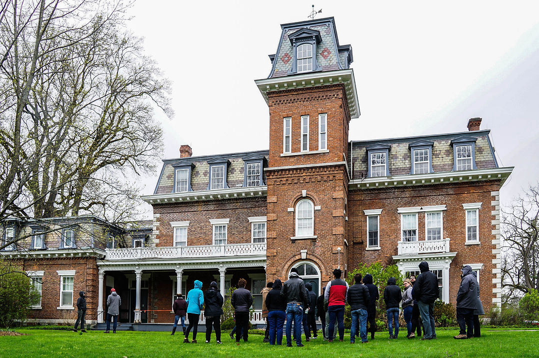 Cornell students looking at the south tower of the Oneida Community Mansion House