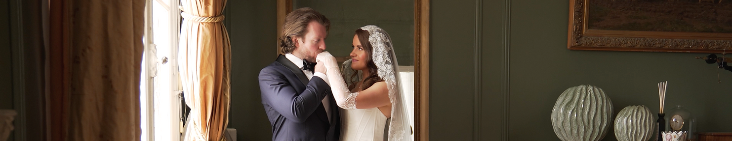 groom kissing his brides' hand