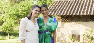Bride standing with her maid of honor for a wedding portrait.