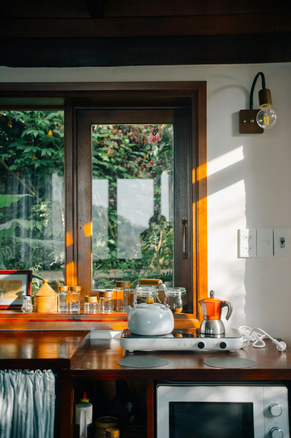 A cozy kitchen interior with morning sunlight, representing the ordinary domestic rhythm in which bonding with an adopted child often quietly happens